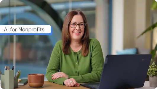 A smiling woman with glasses and a green sweater sits at a desk with a laptop, featured in a video thumbnail titled "AI for Nonprofits."